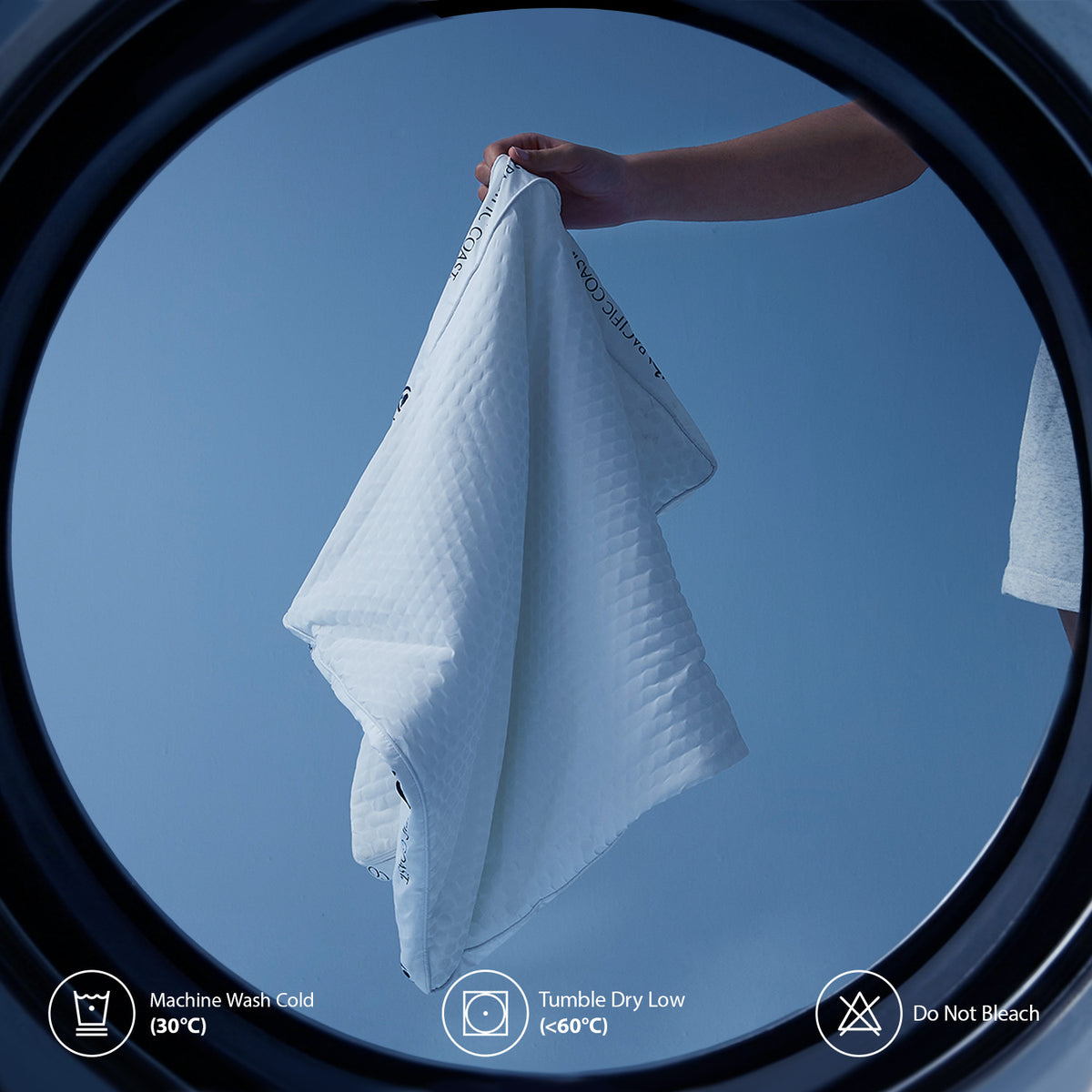 ArcticLayer care illustration showing the washable pillow components and a washing machine